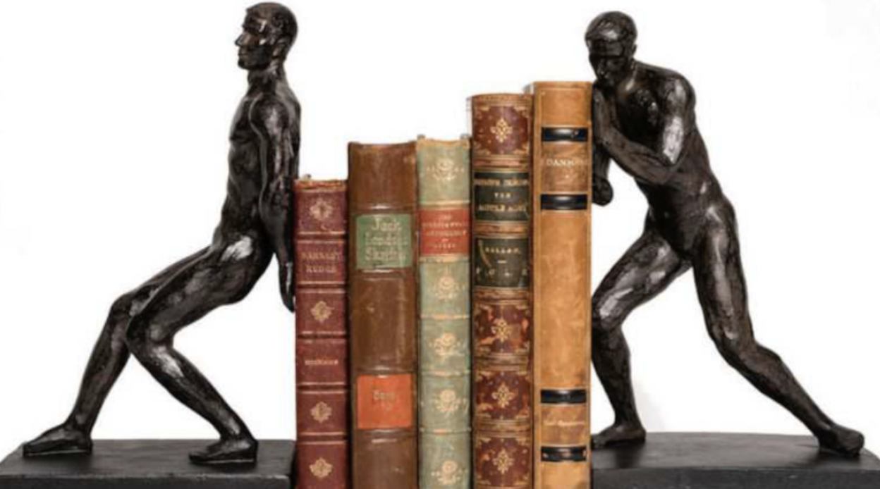 Two men push at either end of a pile of books