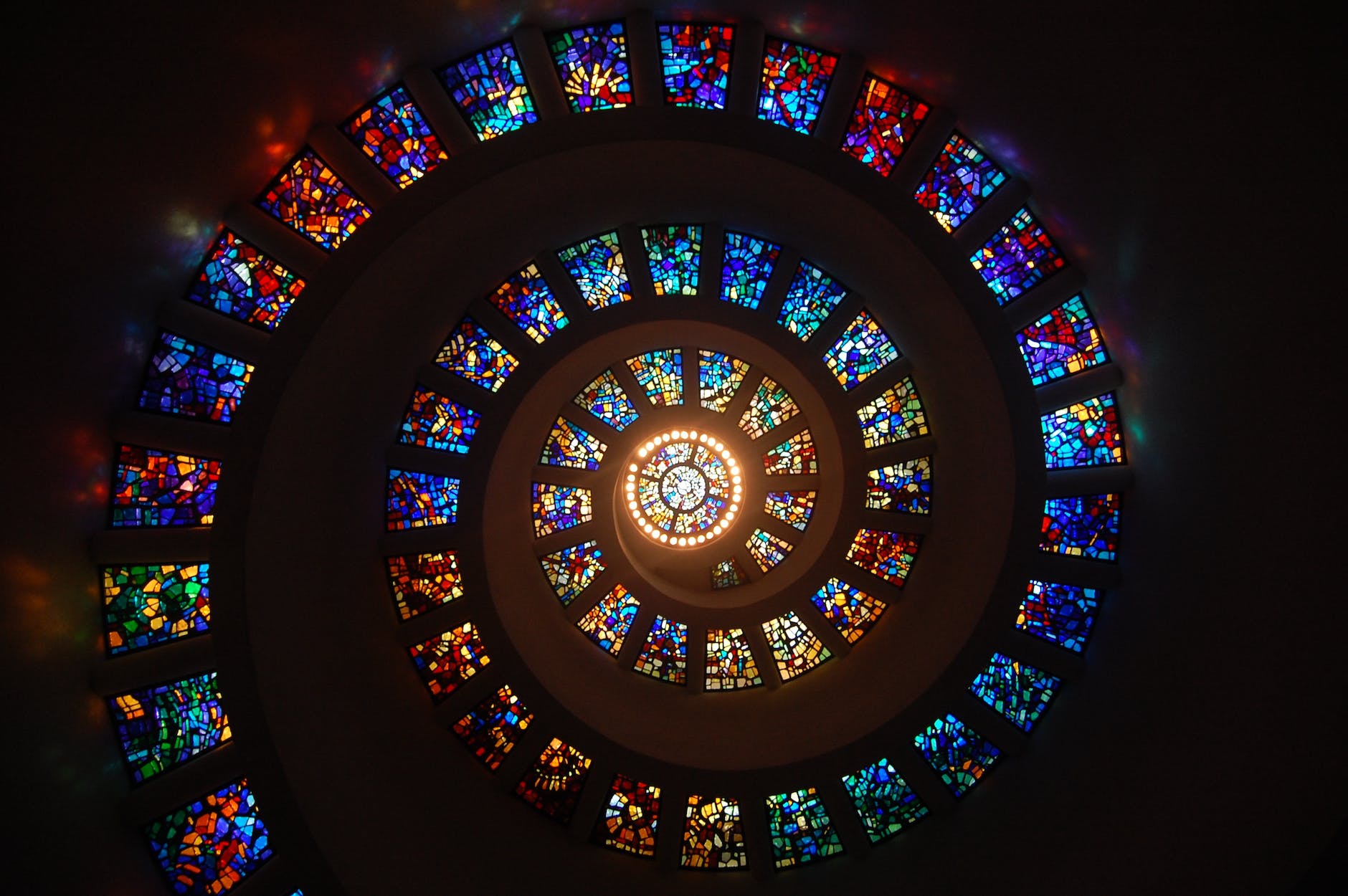 worms eye view of spiral stained glass decors through the roof