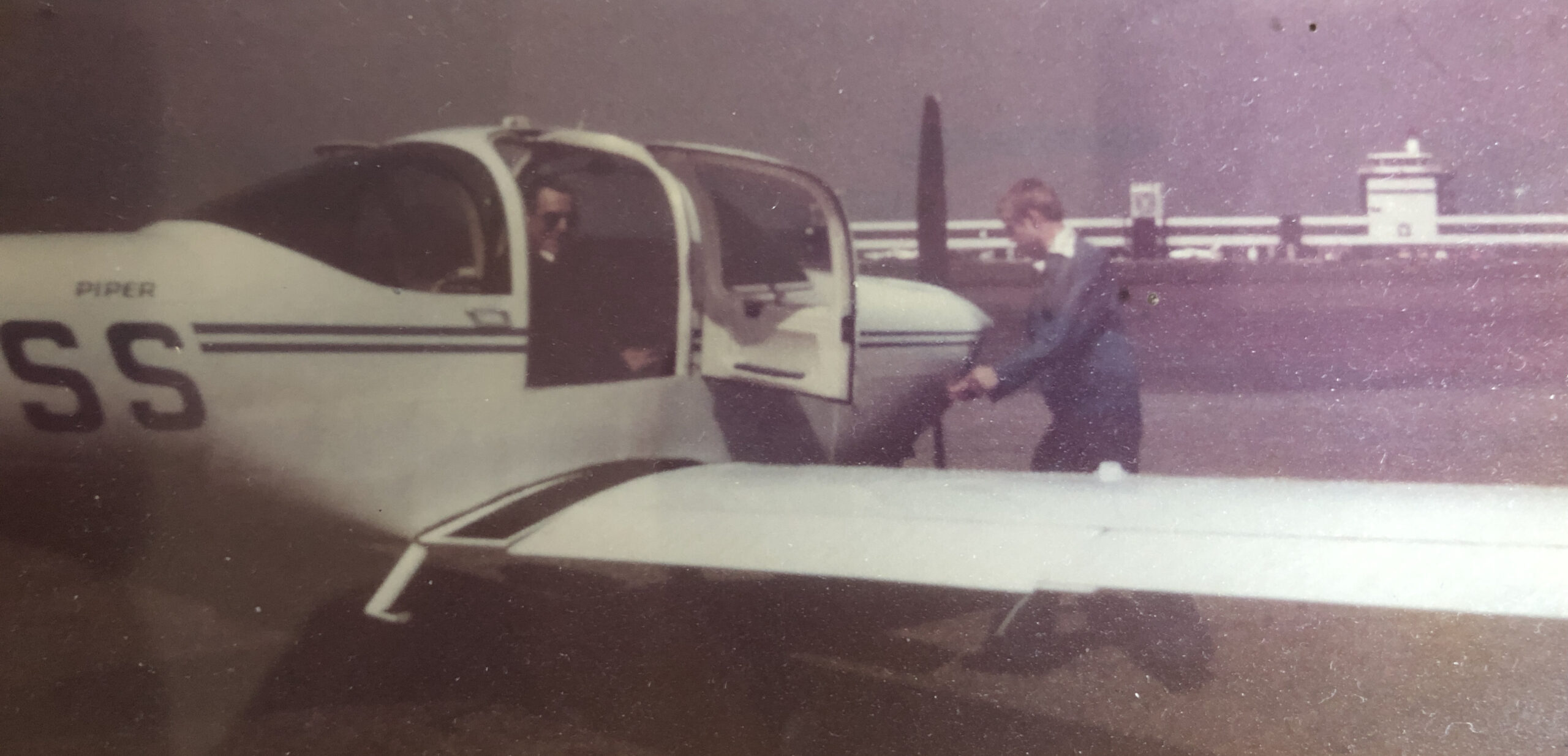 As a trainee pilot, I check the engine prior to taking my Dad across the runway at Cardiff Rhode Airport to get some fuel.